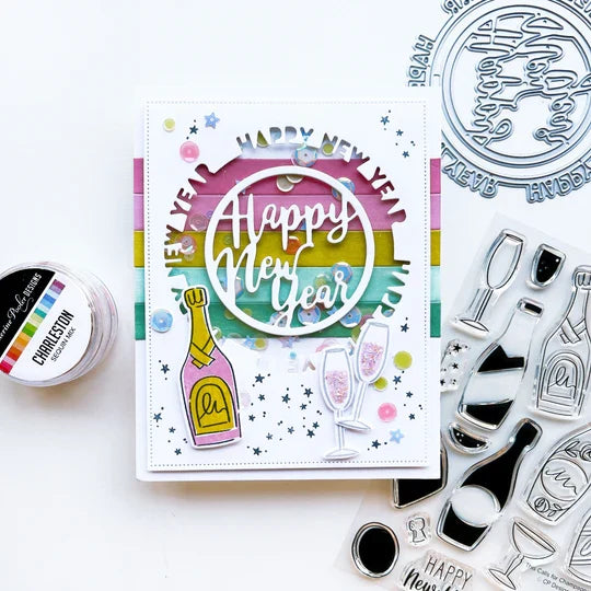 Catherine Pooler - Die - Round of New Year. Add a New Year's greeting with the Round of New Year Dies. This pair of circle word dies can be used together or separately. Layer them with the Circle Dies for festive shaker options. Available at Embellish Away located in Bowmanville Ontario Canada. Example by brand ambassador.