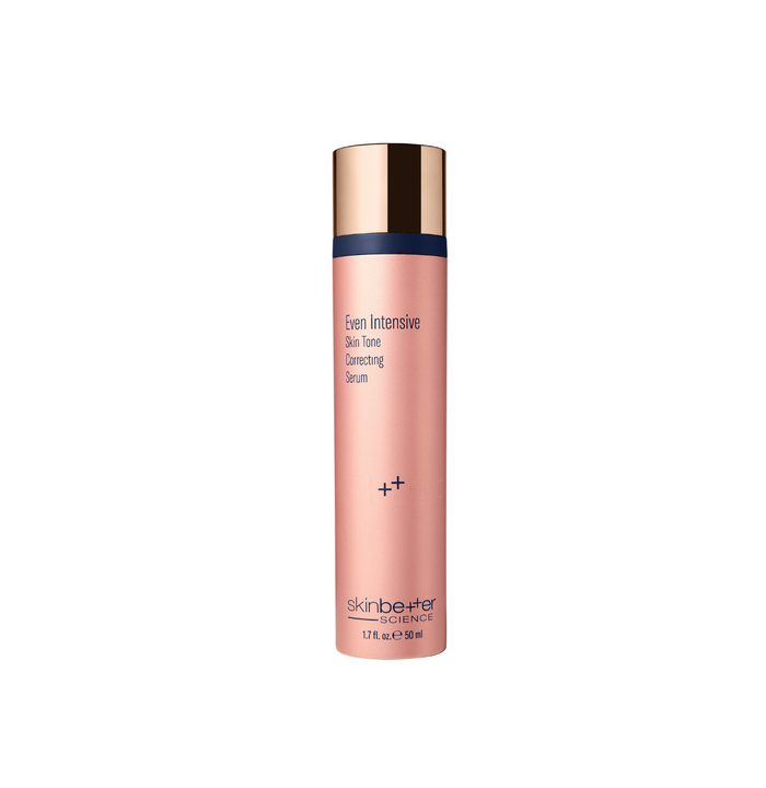Skincare serum bottle with gold cap and pink body on a white background