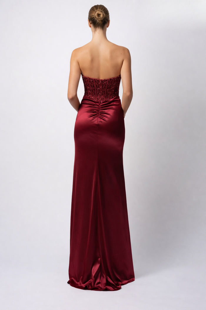 Strapless wine satin evening gown with boned bodice