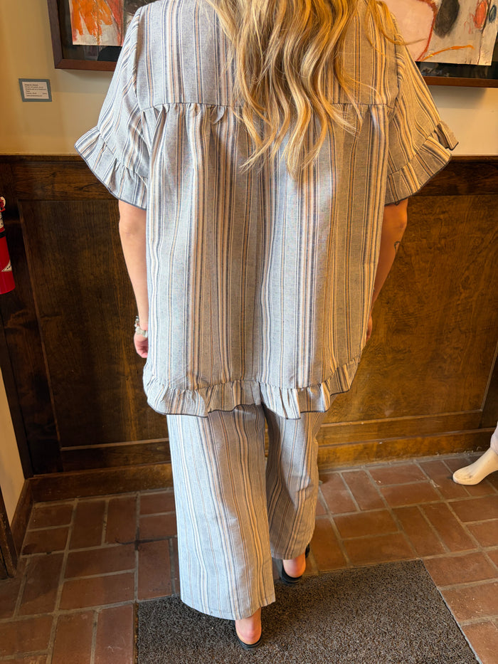 Camille & Co. Earn Your Stripes Pants, stylish striped bottoms with a comfortable fit, displayed on a hanger.