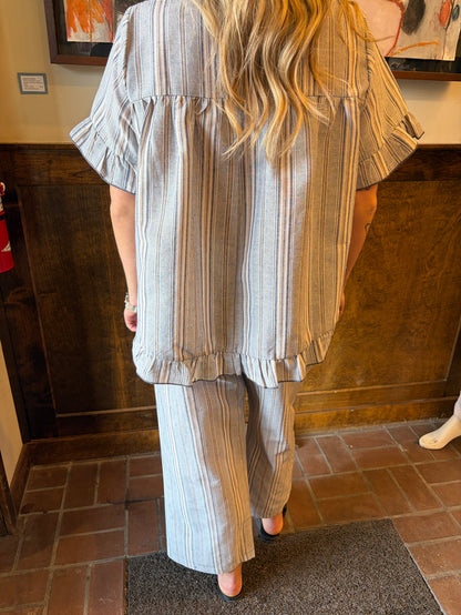 Camille & Co. Earn Your Stripes Pants, stylish striped bottoms with a comfortable fit, displayed on a hanger.