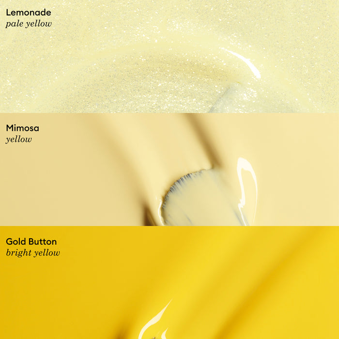 Three horizontal swatches of Manucurist Abricot nail polish in varying yellows: pale yellow labeled “Lemonade,” soft yellow labeled “Mimosa,” and vibrant yellow labeled “Gold Button.”.