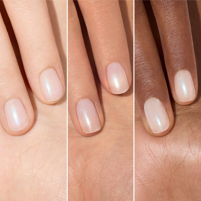 Three hands of different skin tones display fingers with short, neatly manicured nails painted in Manucurist’s Active™ Plump Aqua Glazed—a sheer, shimmery pale pink collagen nail polish—shown side by side for comparison.