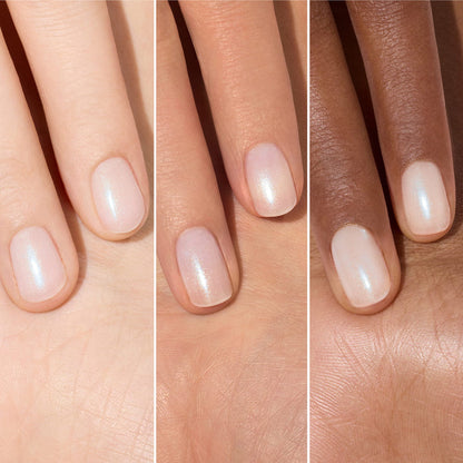 Three hands of different skin tones display fingers with short, neatly manicured nails painted in Manucurist’s Active™ Plump Aqua Glazed—a sheer, shimmery pale pink collagen nail polish—shown side by side for comparison.