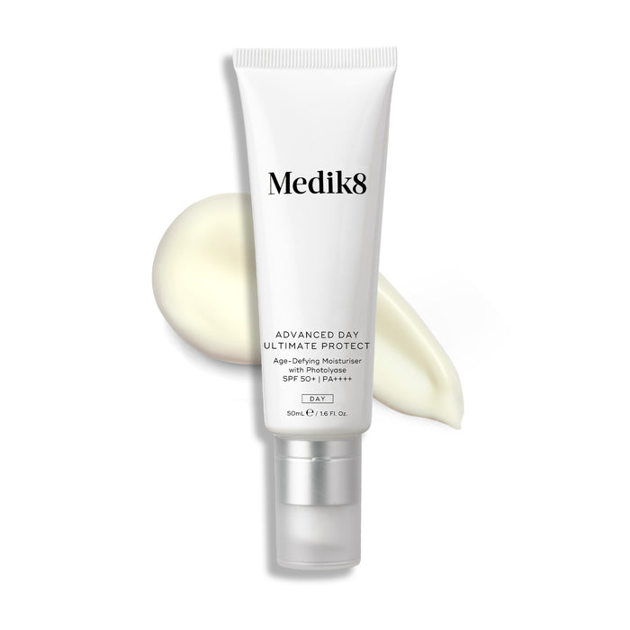 A white tube of Advanced Day Ultimate Protect stands upright, with a swipe of light cream behind it.