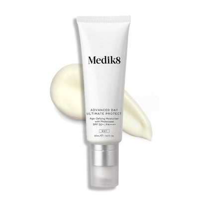 A white tube of Advanced Day Ultimate Protect stands upright, with a swipe of light cream behind it.