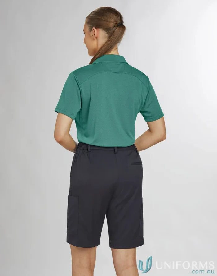 Lady wearing teal polo and dark gray Bermuda shorts from Ladies Utility Cargo collection