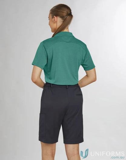 Lady wearing teal polo and dark gray Bermuda shorts from Ladies Utility Cargo collection