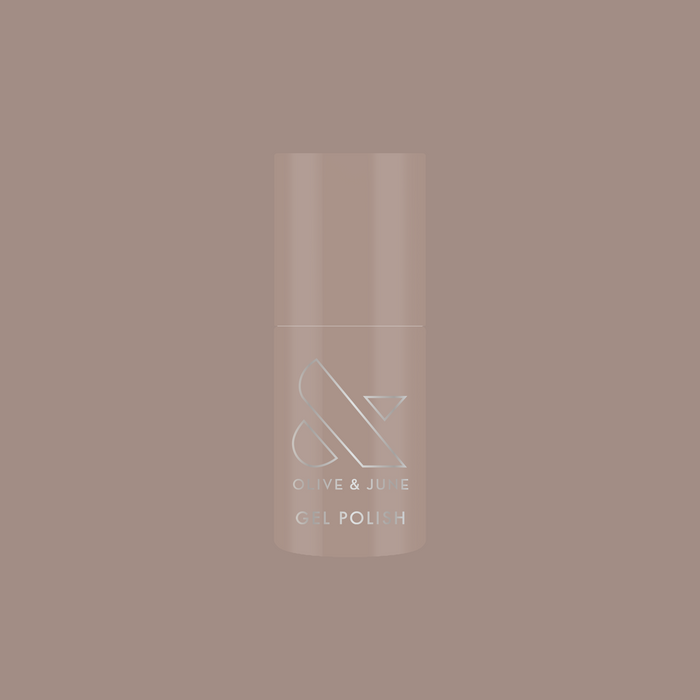 Bottle of AW - Gel polish in warm grey shade for chic, long-lasting manicure by Olive and June on muted background