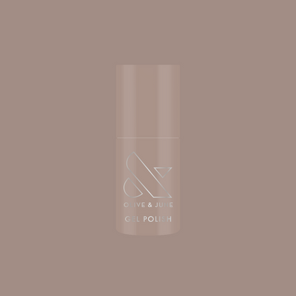 Bottle of AW - Gel polish in warm grey shade for chic, long-lasting manicure by Olive and June on muted background