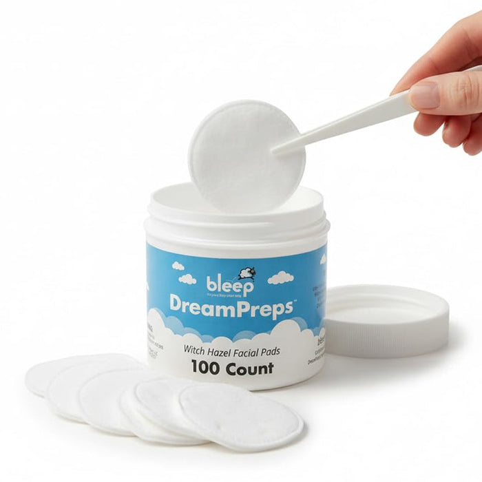 Container of bleep DreamPreps with facial pads and a hand using tweezers  to take out a pad.