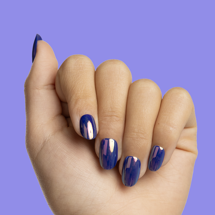 Blue Chrome Magic - Pressies | Short Medium | Round showing glossy electric deep blue press on false nails on hand against purple background