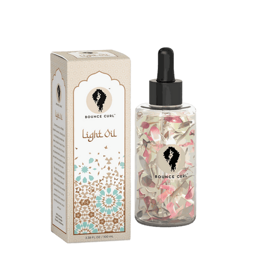 Bounce Curl Light Oil bottle with infused natural flower petals for hair and skin nourishment