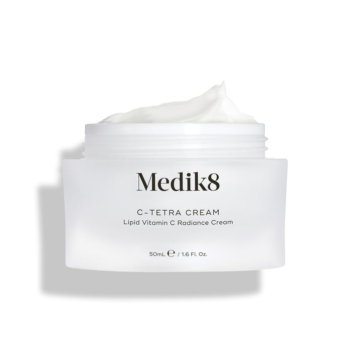 Medik8 C-Tetra Cream jar displayed open against a clean white background with soft shadows. The white, frosted-glass jar features the Medik8 logo and is labeled "C-TETRA CREAM Lipid Vitamin C Radiance Cream" in a 50mL size. A thick swirl of white cream is visible on top of the jar, highlighting its moisturising texture.