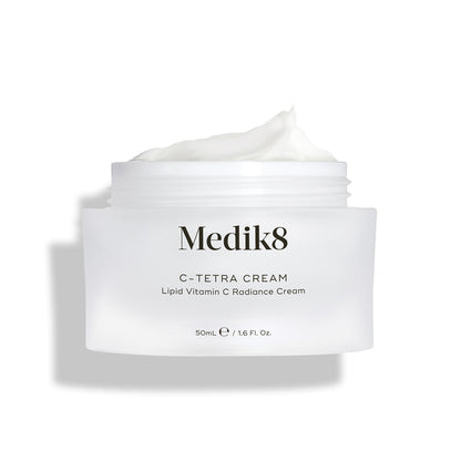 Medik8 C-Tetra Cream jar displayed open against a clean white background with soft shadows. The white, frosted-glass jar features the Medik8 logo and is labeled "C-TETRA CREAM Lipid Vitamin C Radiance Cream" in a 50mL size. A thick swirl of white cream is visible on top of the jar, highlighting its moisturising texture.