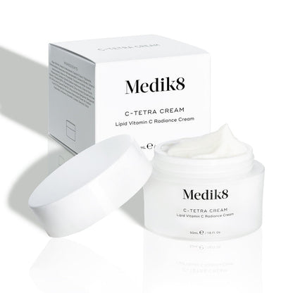 Medik8 C-Tetra Cream jar and its white cardboard carton displayed on a clean white background with soft shadows. The open white, frosted-glass jar features the Medik8 logo and is labelled "C-TETRA CREAM Lipid Vitamin C Radiance Cream" in a 50mL size. A thick swirl of white cream is visible on top of the jar, with the white box behind it showing the product name and a partial ingredients list.