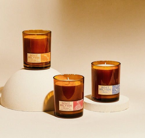 Amber glass candles trio with cotton wicks and Honey Hill Farm labels