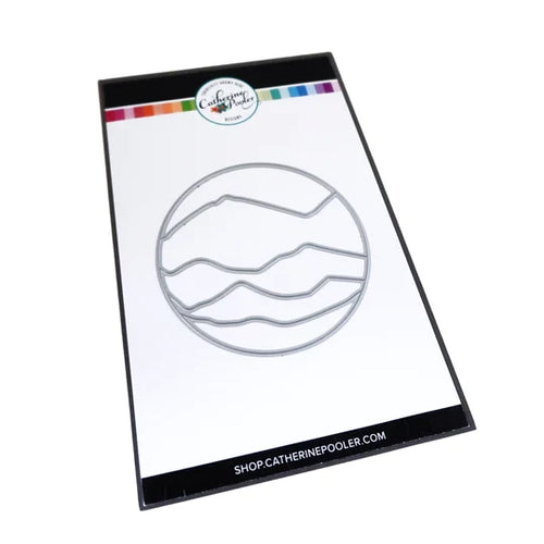 Catherine Pooler - Die - Circle Landscape. Take your scene building up a level with the Circle Landscape Die by adding a backdrop of mountains or water. Or just to add some fun pops of colour. Available at Embellish Away located in Bowmanville Ontario Canada.