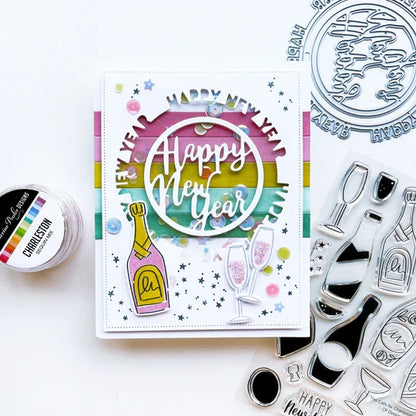 Catherine Pooler - Die - Round of New Year. Add a New Year's greeting with the Round of New Year Dies. This pair of circle word dies can be used together or separately. Layer them with the Circle Dies for festive shaker options. Available at Embellish Away located in Bowmanville Ontario Canada. Example by brand ambassador.