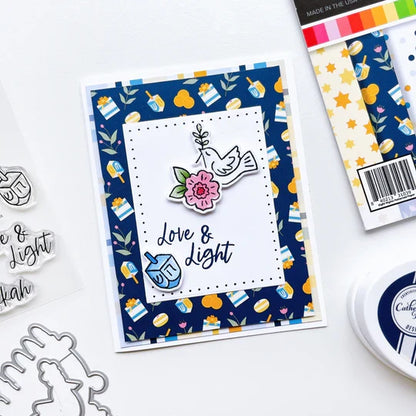 Catherine Pooler - Patterned Paper - Eight Nights. Create gorgeous Hanukkah cards and paper projects with the Eight Nights Patterned Paper. Traditional colors of Whipped Honey, Shea Butter, Sauna, Tranquil, On the Lake, Juniper Mist, Rose Petals & Sage. Available at Embellish Away located in Bowmanville Ontario Canada. Example by brand ambassador.