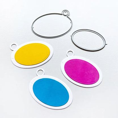 Catherine Pooler - Tag Die - Ink Swatch. Make your own colorful swatch ring. Die cut and direct to paper your center oval. Glue them to the die cut tag bases and tie them together with a piece of twine or us a binder ring for easy access. Available at Embellish Away located in Bowmanville Ontario Canada.