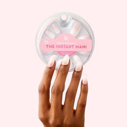 CCT Gradient - Press-On | Medium | Almond showing hand with medium almond press-on nails in white to sheer pink ombré mani