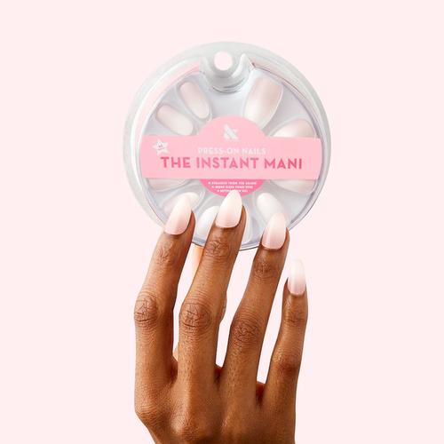 CCT Gradient - Press-On | Medium | Almond showing hand with medium almond press-on nails in white to sheer pink ombré mani