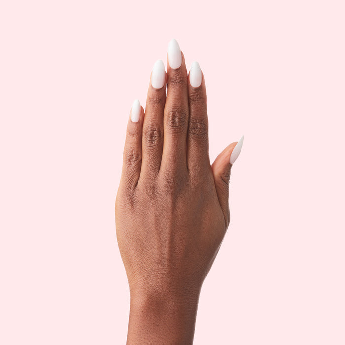 CCT Gradient - Press-On | Medium | Almond showing hand with medium almond-shaped false nails in soft white to sheer pink ombré manicure