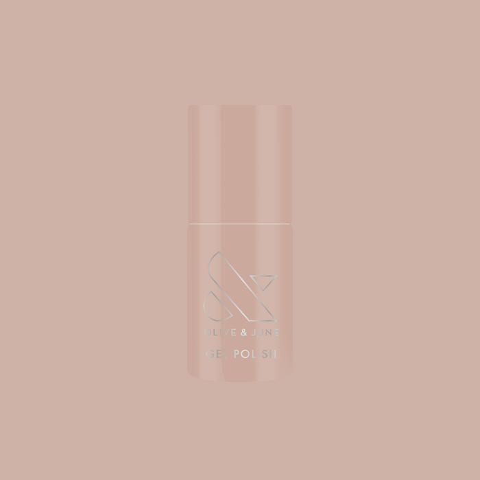 Bottle of CDJ - Gel nail polish by Olive and June in creamy neutral shade on matching soft background