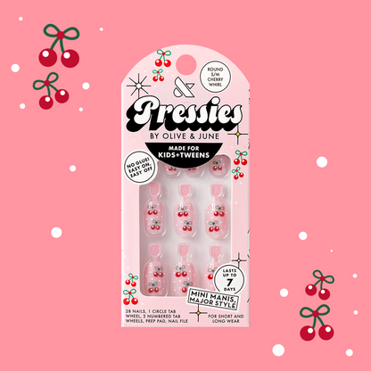 Cherry Whirl - Pressies | Short Medium | Round showing pastel pink press on nails with cherry designs in packaging on pink background