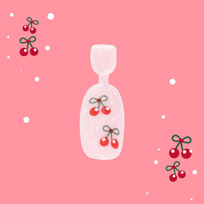 Cherry Whirl - Pressies | Short Medium | Round showing pastel pink press on nail with red cherry design on pink background