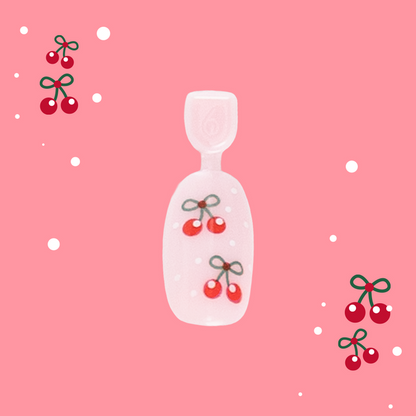 Cherry Whirl - Pressies | Short Medium | Round showing pastel pink press on nail with red cherry design on pink background