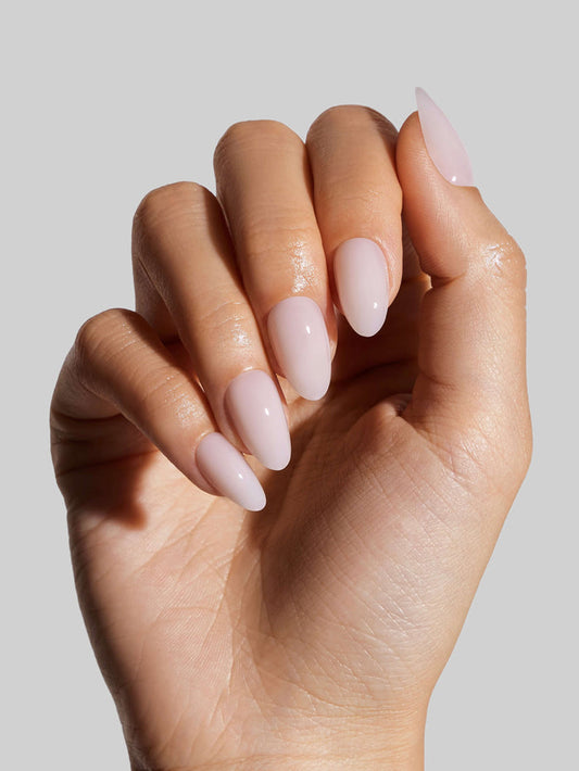 Hand with Coconut Milk  press-on nails on a neutral background