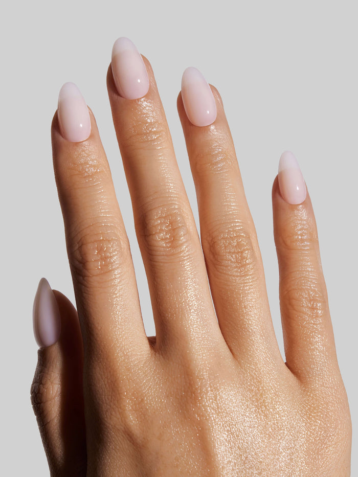Close-up of a hand with Coconut Milk  press-on nails on a neutral background