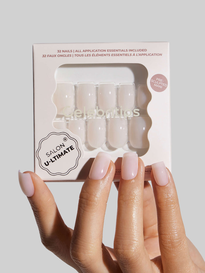 Nail art kit with 'Salon Ultimate' branding held by a hand with pink nails.