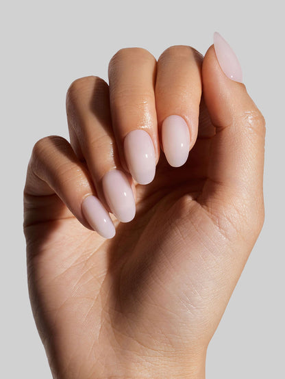 Close-up of a hand with Coconut Milk  press-on nails on a neutral background