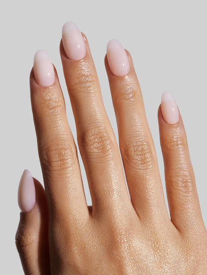Close-up of a hand with Coconut Milk  press-on nails on a neutral background