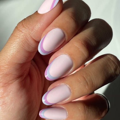 Double French - Press-On | Medium | Oval showing medium oval false nails with two-tone pastel french tip manicure on hand