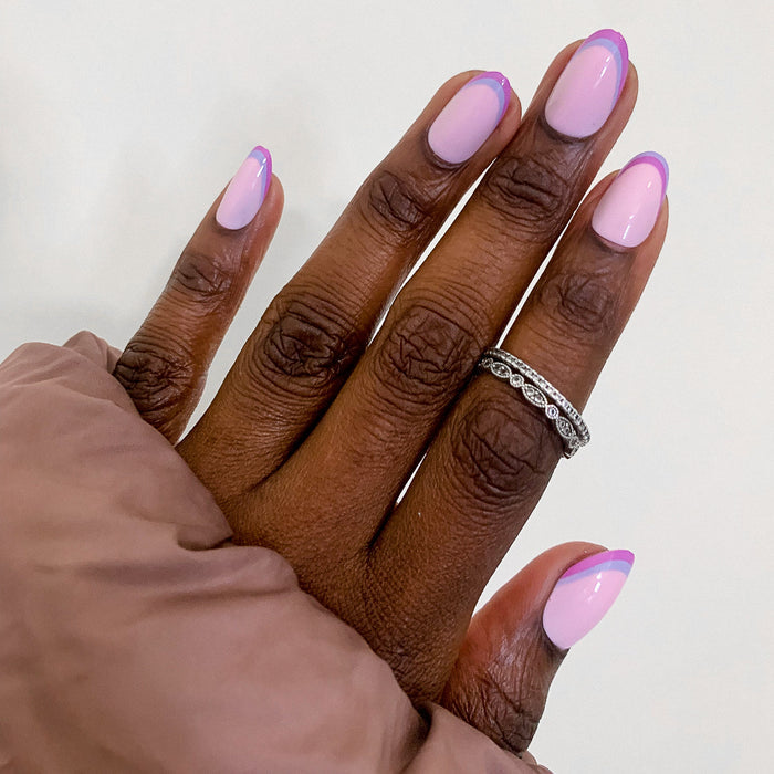 Double French - Press-On | Medium | Oval showing medium oval false nails with dual pastel pink french tip manicure on hand