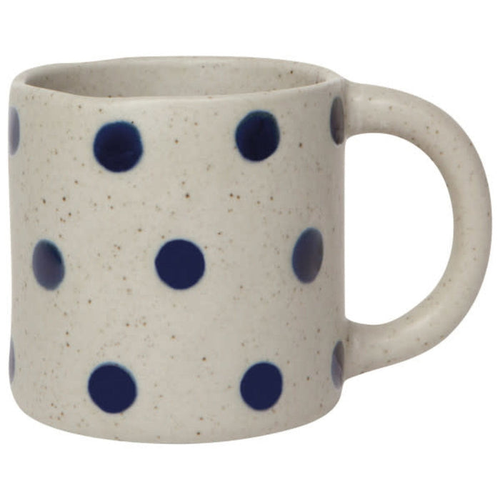 Speckled cream ceramic mug with navy dot pattern and right-side handle