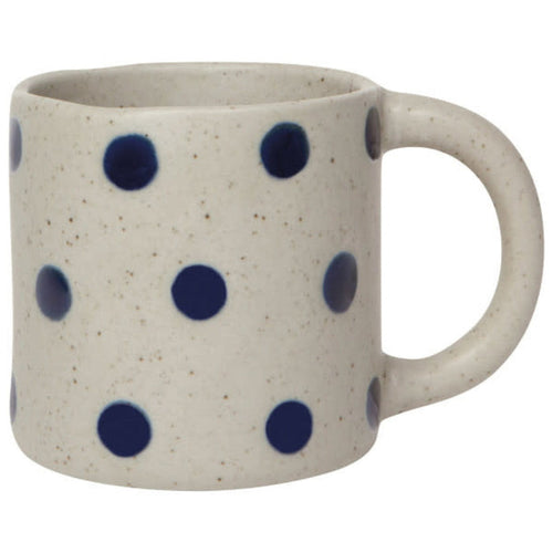 Speckled cream ceramic mug with navy dot pattern and right-side handle