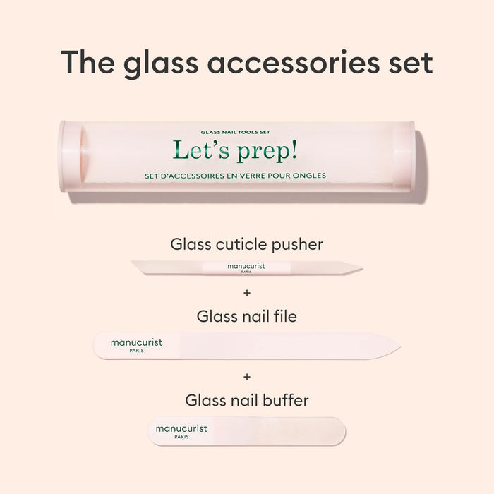 An image of the Manucurist-us Glass nail accessory trio, including a cylindrical case labeled "Lets prep!", a glass nail buffer, cuticle pusher, and nail file, all neatly arranged on a light background.