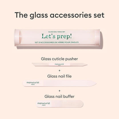 An image of the Manucurist-us Glass nail accessory trio, including a cylindrical case labeled "Lets prep!", a glass nail buffer, cuticle pusher, and nail file, all neatly arranged on a light background.