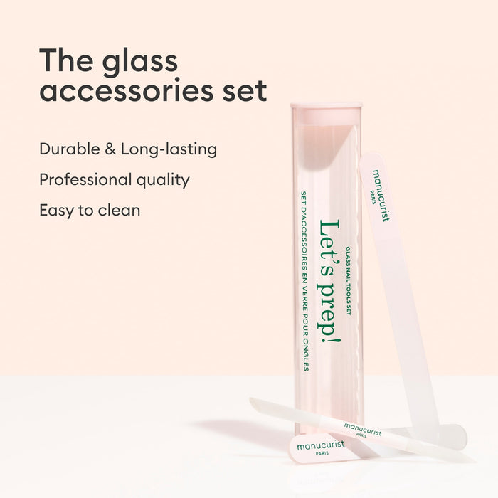 A pink and clear Manucurist-us case labeled "Lets prep!" stands upright beside a glass nail file and cuticle pusher. Text: Glass nail accessory trio—durable, long-lasting, professional quality, easy to clean.