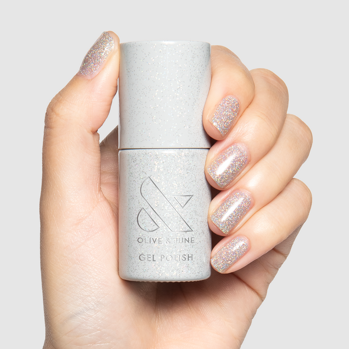 Glitter Department Gel on short natural nails in holographic silver glitter for a sparkle-filled manicure by Olive and June