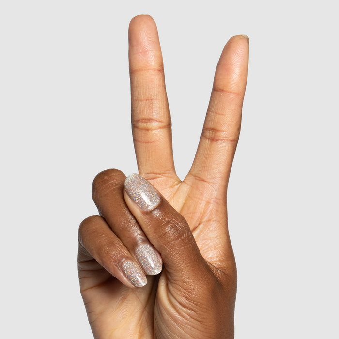 Glitter Department Gel on medium-length natural nails in holographic silver for a sparkling at-home manicure
