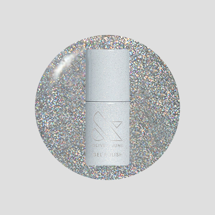 Glitter Department Gel bottle on a holographic silver glitter background for a festive at-home manicure by Olive and June