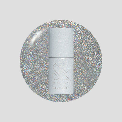 Glitter Department Gel bottle on a holographic silver glitter background for a festive at-home manicure by Olive and June
