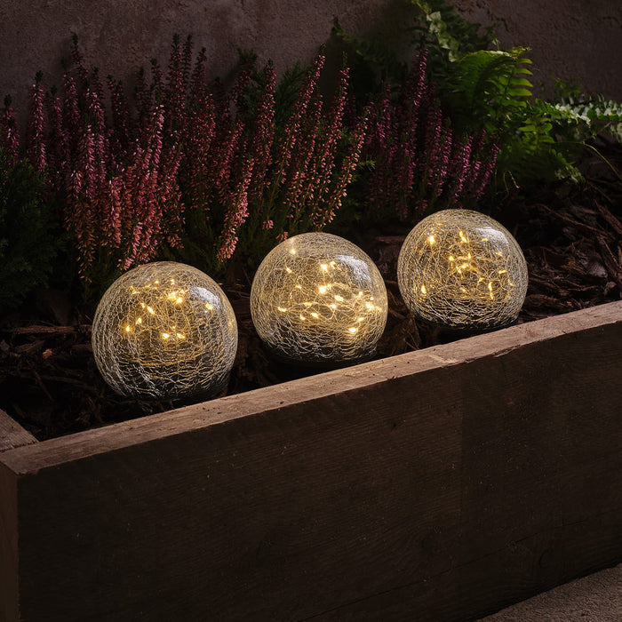 3 crackle glass solar stake lights in a planter