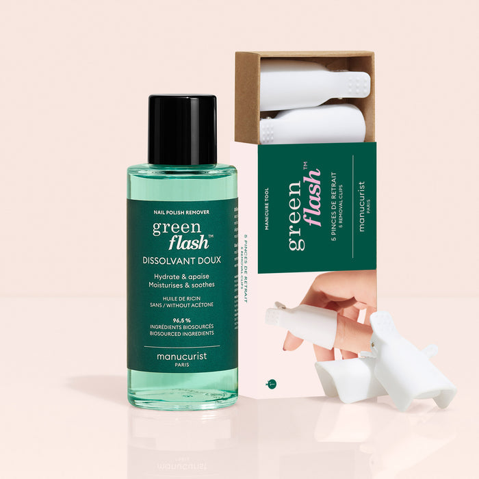 The Manucurist-us Green Flash™ Remover  Clips Duo, featuring a plant-based remover bottle and a box of five white finger clips for gentle polish removal, is displayed against a soft beige background.